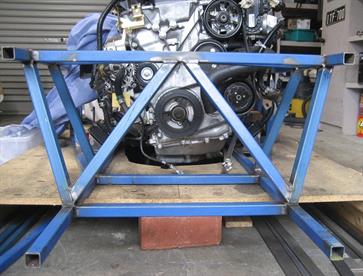 Cross bracing adds to the torsional strength of the front end.  The lower end of the cross brace fits directly behind the location for the lower wishbone mounting positions, thus adding even more strength to this high stress area.