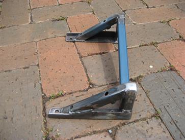 The steering rack mount.  It's removable and adjustable by adding spacers under the bracket and intentionally made lower than the desired height to provide a full range of adjustment to remove bump steer.  If the ride height of the car is altered then the rack can be repositioned accordingly.