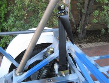 Seatbelt retractor and upper pivot in their location and tacked in place