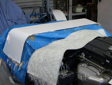 White gel coat was applied and once it tacked off layers of fibreglass mat and resin were added.