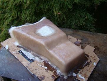 The buck after layers of fibreglass have been applied to form the mould from which the centre console will be made.